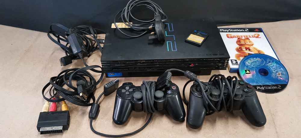 Lot 229: Sony PlayStation 2 Console with Controllers and Games. Tested for Power