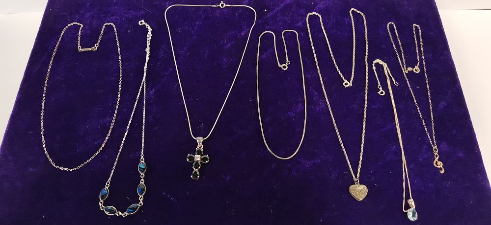 Lot 305: A Collection of Silver Toned Necklaces and Pendants