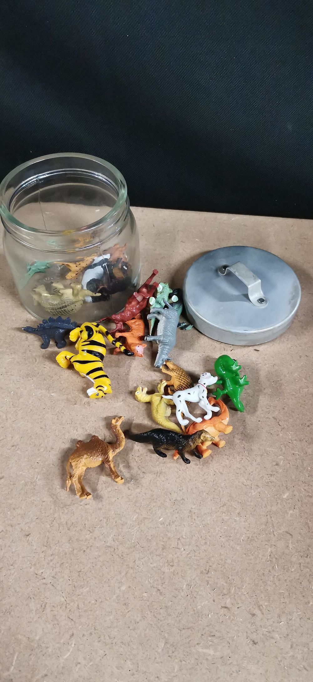 Lot 234: A Collection of Plastic Toy Animals and a Glass Jar