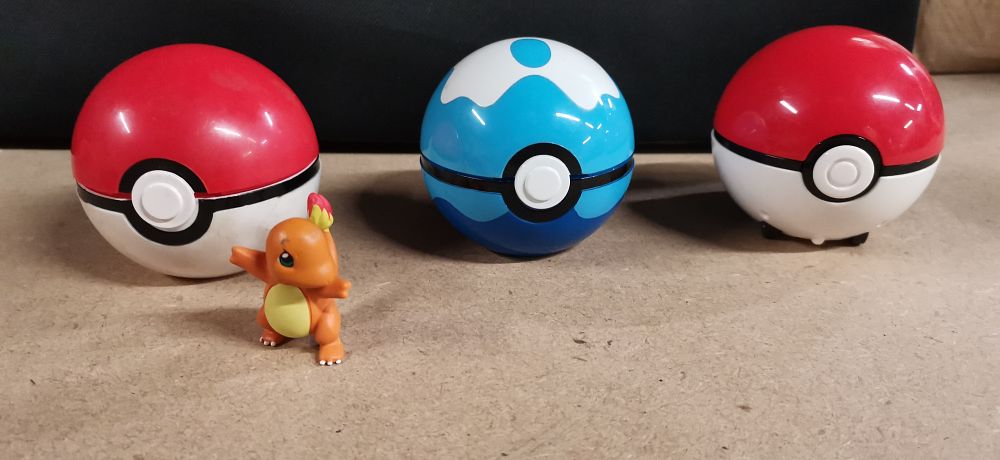 Lot 237: A Collection of Pokemon Poke Ball Containers and Charmander Figure