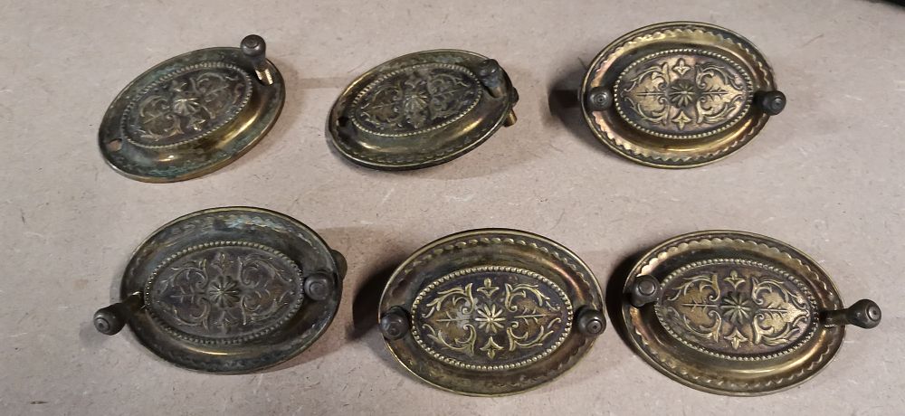 Lot 252: A Collection of Embossed Brass Furniture Handles