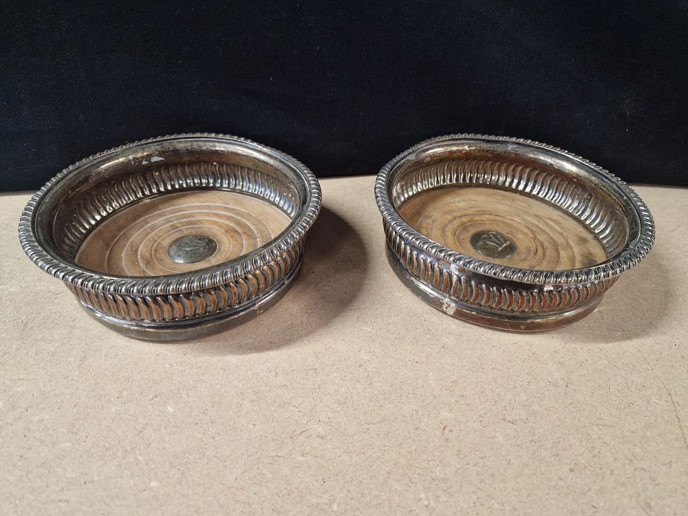 Lot 289: A Pair of Silver Plated Wine Bottle Coasters