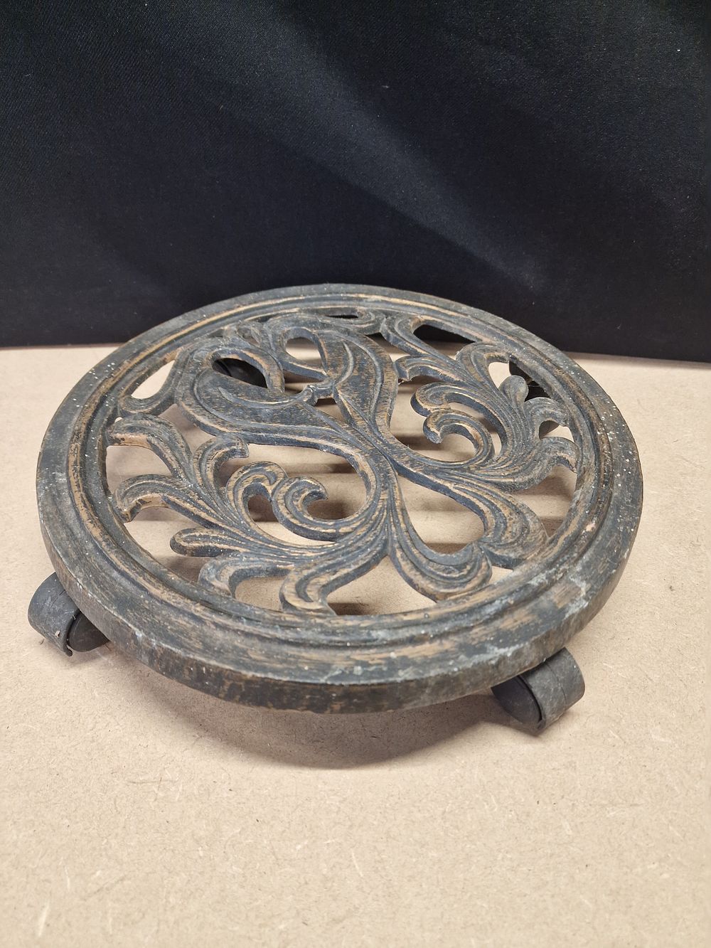 Lot 333: Cast Iron Circular Scrollwork Plant Caddy with Caster Wheels