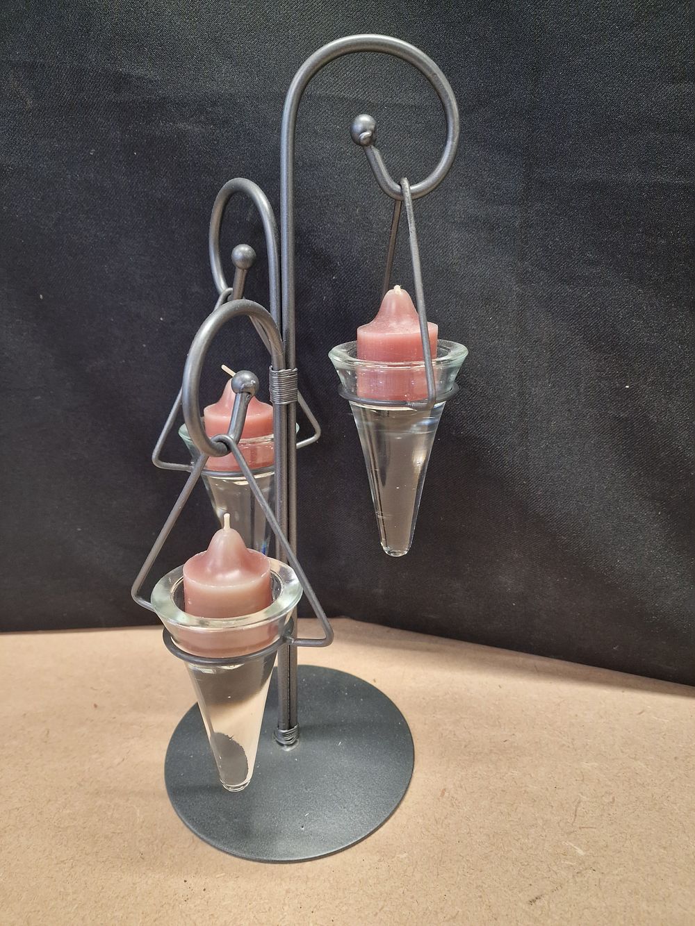 Lot 345: Black Metal Scrolling Candle Holder with Conical Glass Vessels