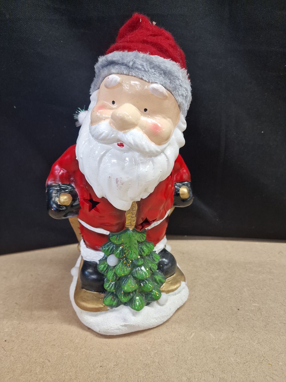 Lot 369: Resin Santa Claus Figurine Holding a Christmas Tree