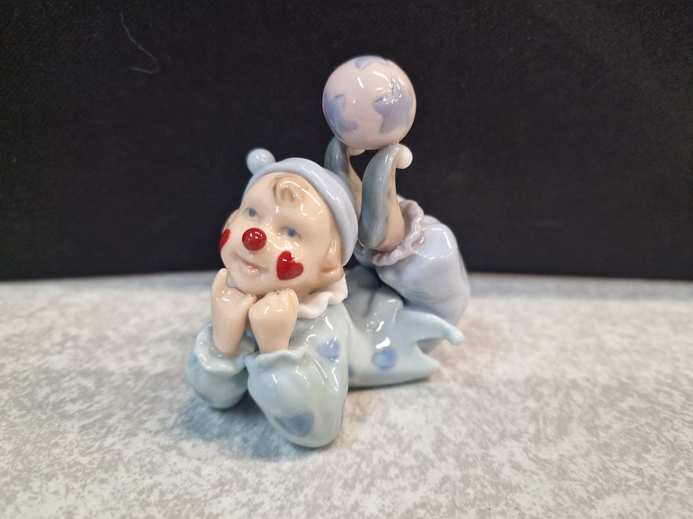 Lot 400: Glazed Porcelain Reclining Clown Figurine with Ball