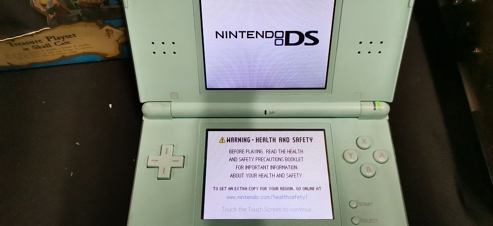 Lot 265: Two Items Including Nintendo DS Lite Console and Mario Game. Tested for Power