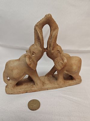 Hand-carved Soapstone Elephant Sculpture, Mid-20th Century, Arching Trunks. A hand-carved 