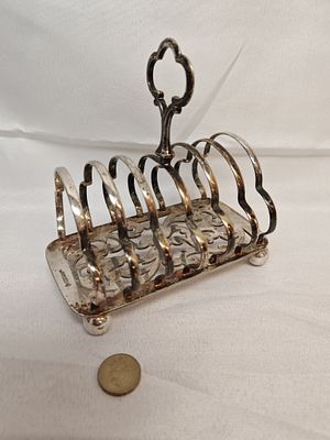 Silver Plated Seven-Bar Toast Rack, Late Victorian Style, Pierced Scrollwork Base. A late 