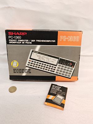 Sharp PC-1360 Pocket Computer with CE-2H32M RAM Expansion and Original Packaging, c. 1986. This 