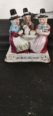 Victorian German Fairing The Welsh Tea Party. A multi-colour porcelain figurine depicting three 