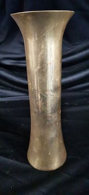 Vintage Flared Brass Bud Vase. A tall, flared brass-coloured metal vase featuring a tarnished 