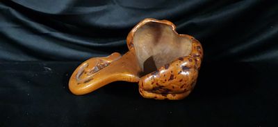 Carved Organically Shaped Mottled Vessel with Scroll Handle. An orange-brown carved vessel 