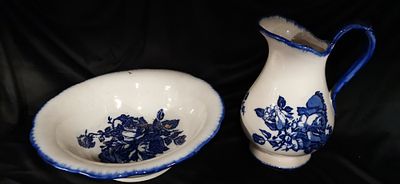 A Victoria Ironstone Pitcher and Bowl Set. A white and blue ceramic pitcher and bowl set 