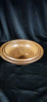 Handcrafted Turned Oak Wood Bowl. A medium brown turned oak wood bowl featuring a tiered rim and 