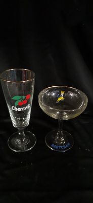 Two Vintage Babycham and Cherry B Stemmed Glasses. Two clear glass stemmed drinking vessels 