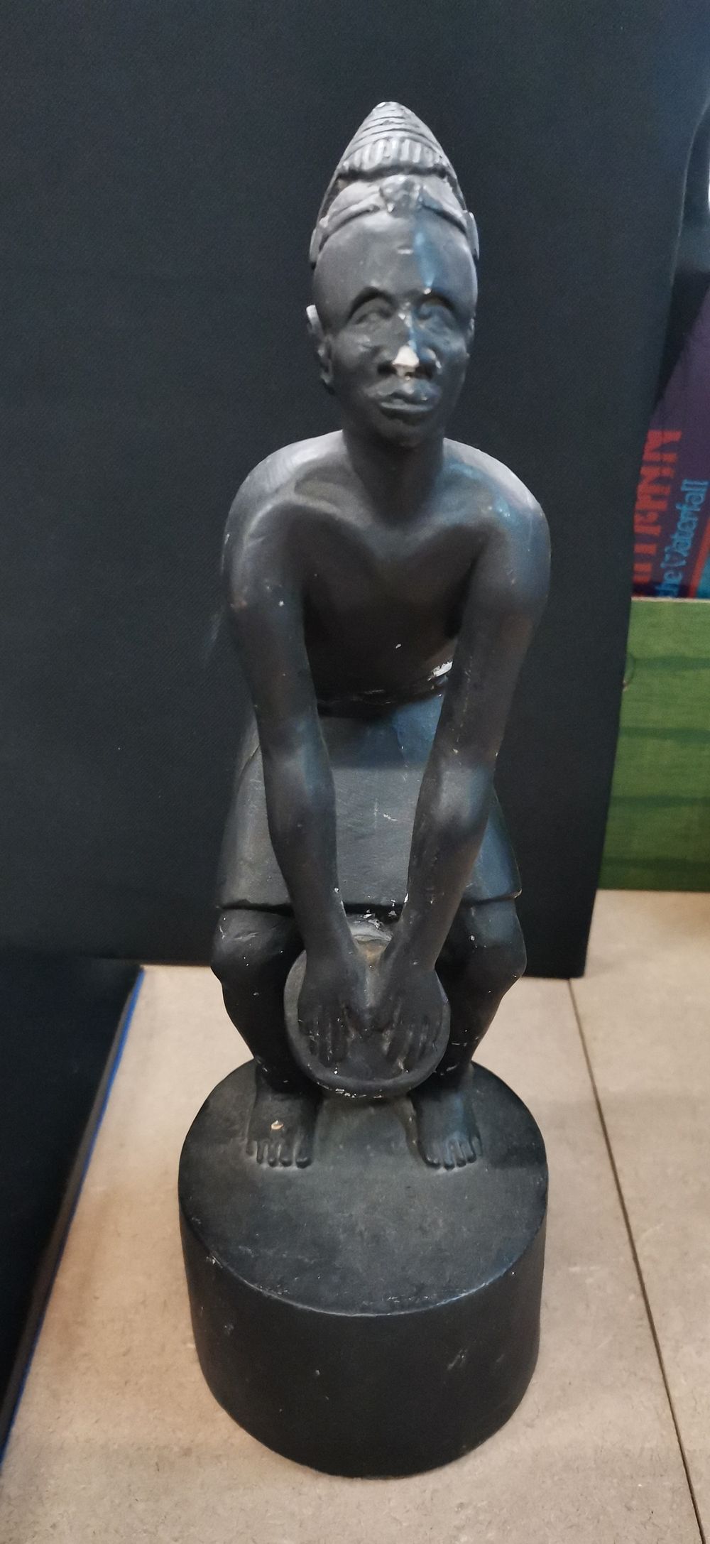 Lot 411: Black figurative sculpture of a man playing a drum