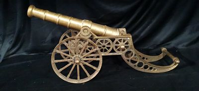 A Single Brass-coloured Decorative Model Cannon on Carriage. A single brass-coloured decorative 