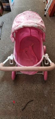 Pink and White Toy Doll Pram with Rabbit Pattern. A pink and white toy doll pram featuring a 