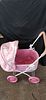 Pink and White Toy Doll Pram with Rabbit Pattern. A pink and white toy doll pram featuring a Image - 1