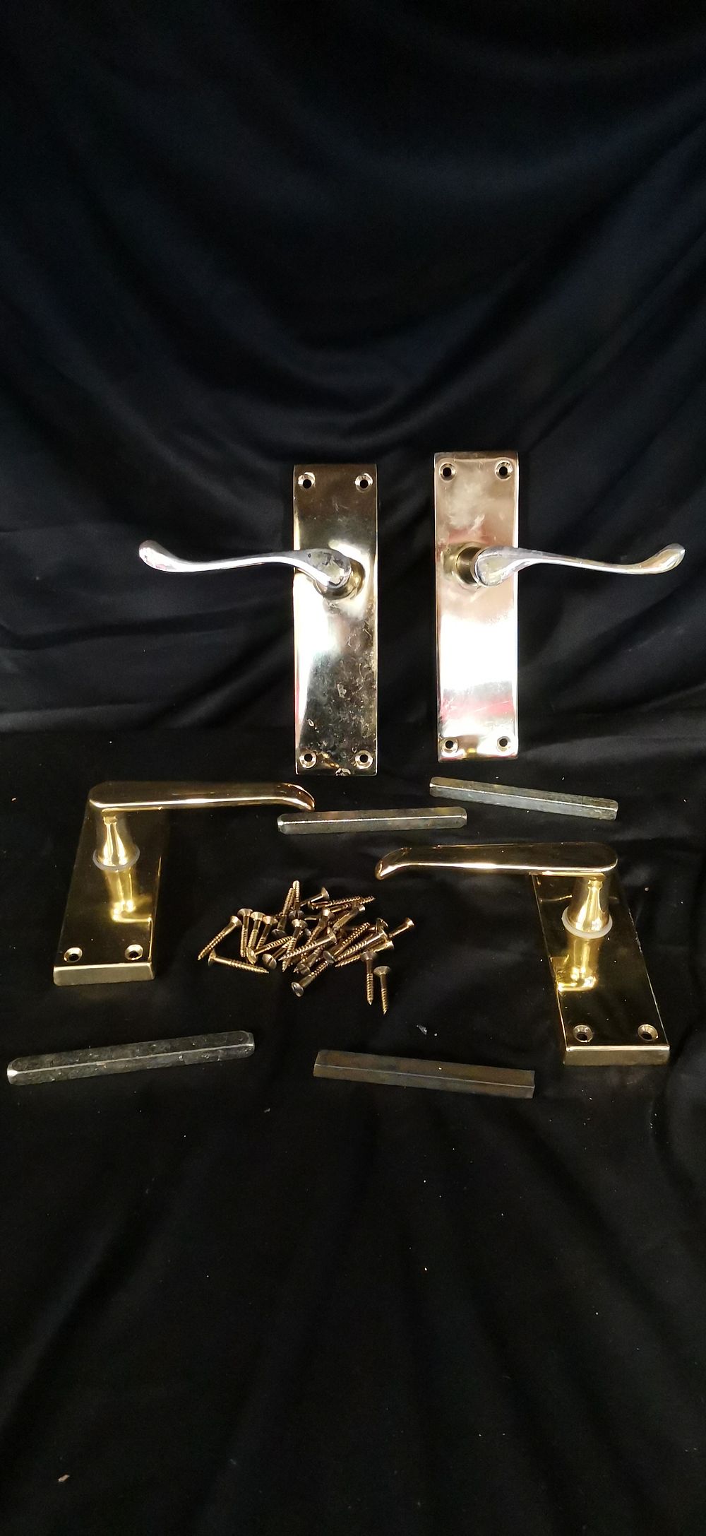 Lot 255: A Collection of Polished Brass Victorian Scroll Door Handles
