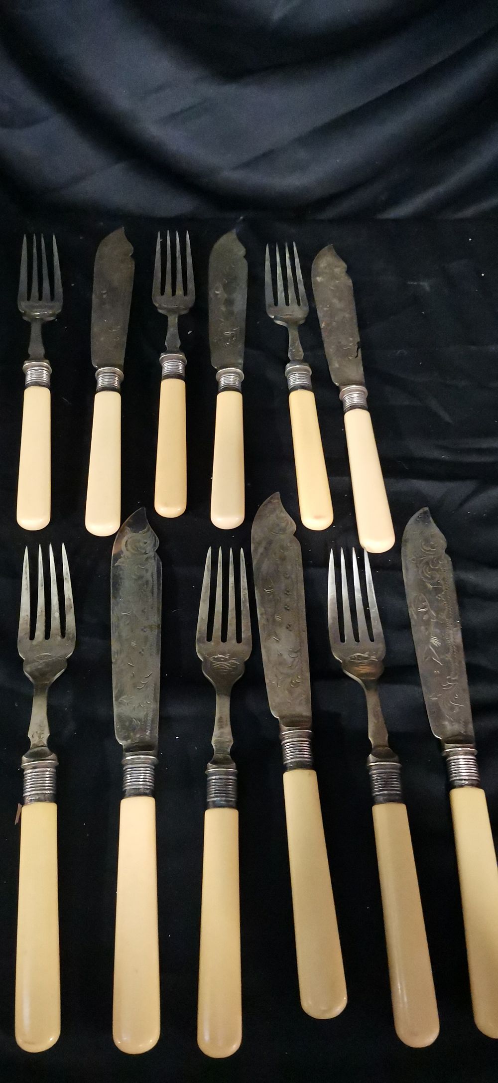 Lot 284: A Collection of Silver Toned and Cream Coloured Fish Cutlery with Sterling silver Collars,