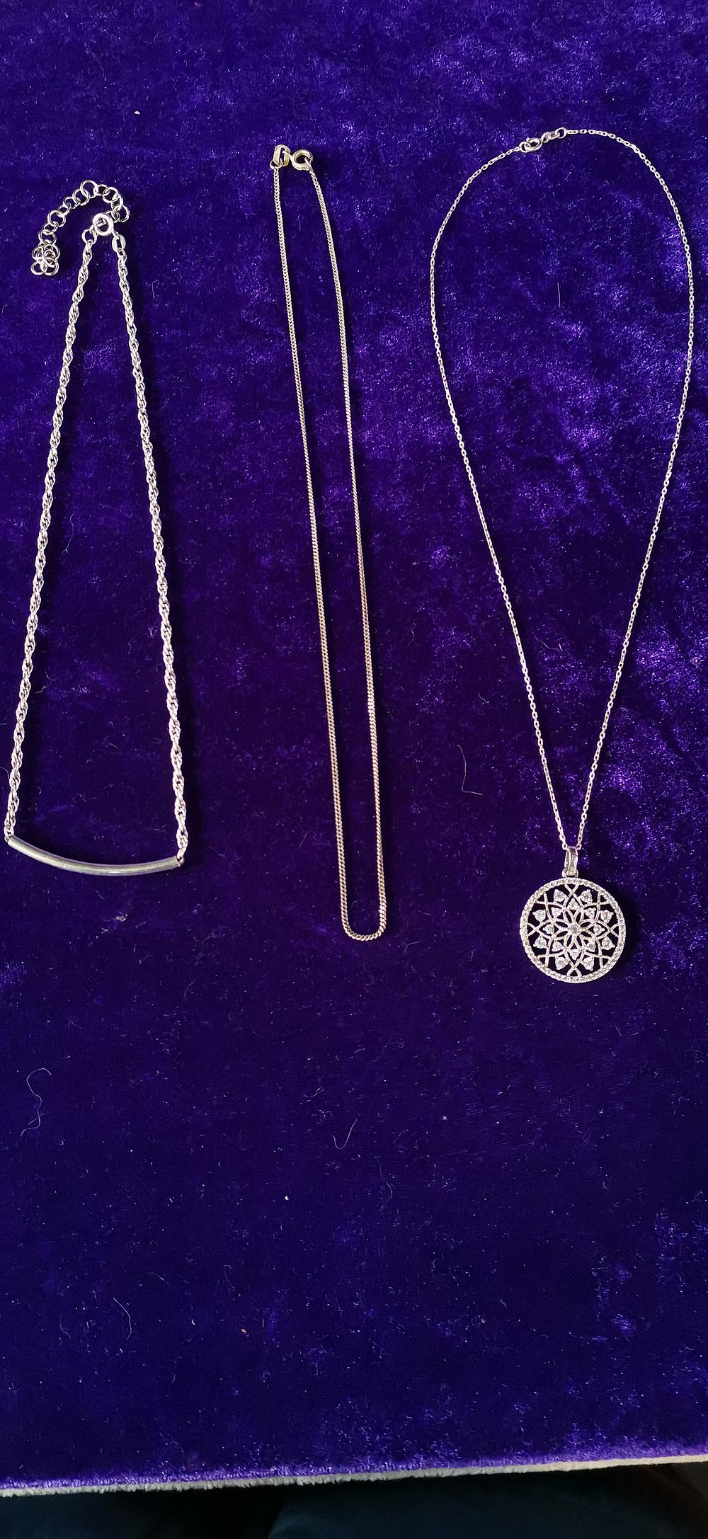 Lot 312: A Trio of Sterling Silver Necklaces with Pendants
