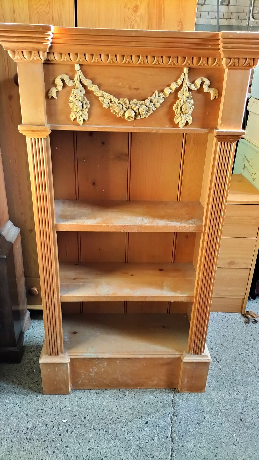 Lot 305: A Carved Wood Open Bookcase with Floral Garland, COLLECTION ONLY.