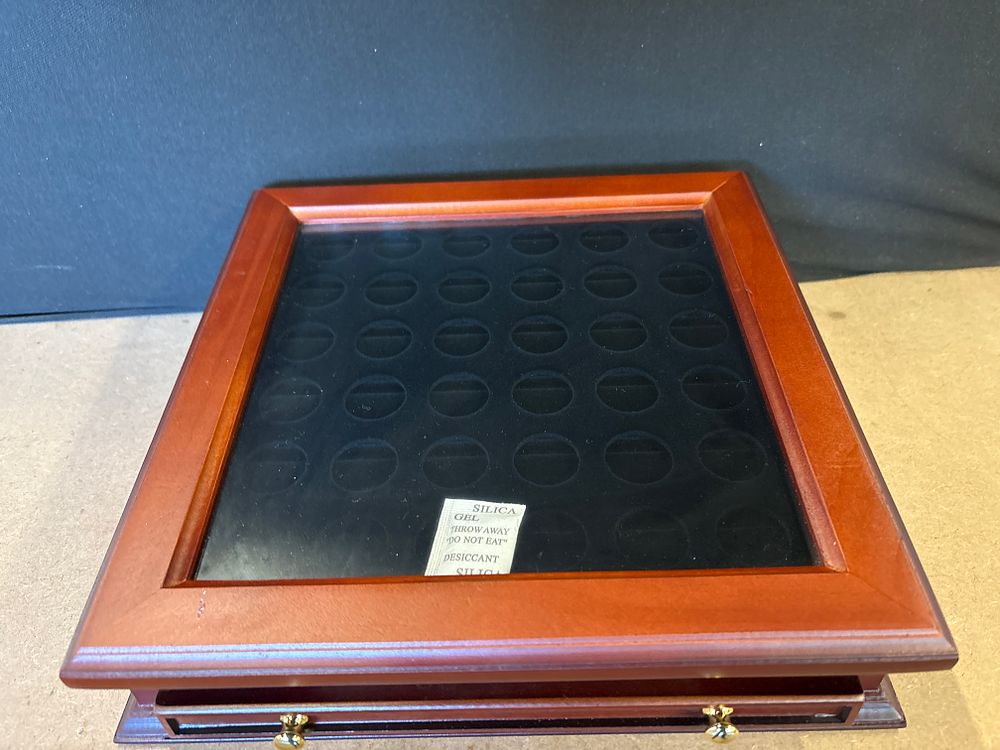 Wooden Sacagawea Dollar coin collector display case. A reddish-brown wooden coin collector 