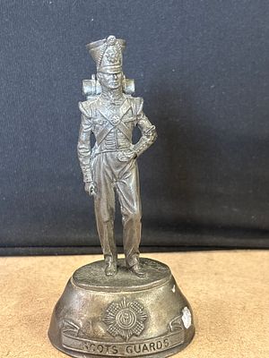 Scots Guards metal soldier figurine on inscribed base. A metal figurine depicting a Scots Guards 