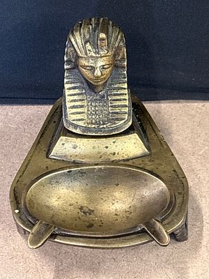 Egyptian Revival Brass Pharaoh Ashtray and Trinket Dish. A two-piece brass ashtray and trinket 