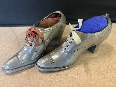 A Pair of Victorian Style Metal Shoe Pincushions. Two metal high-heeled shoe pincushions 