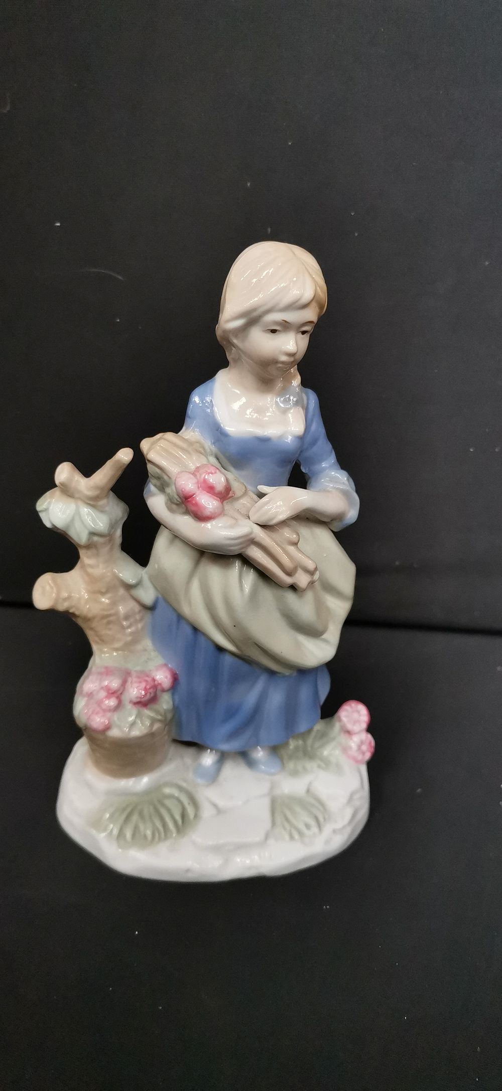Lot 437: Porcelain figurine of a girl with flowers and wood
