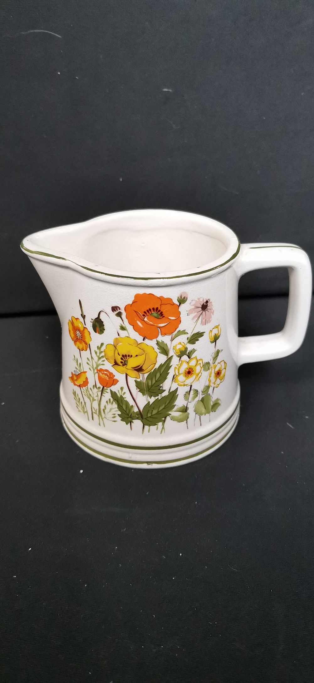 Lot 441: A white ceramic creamer with floral decoration
