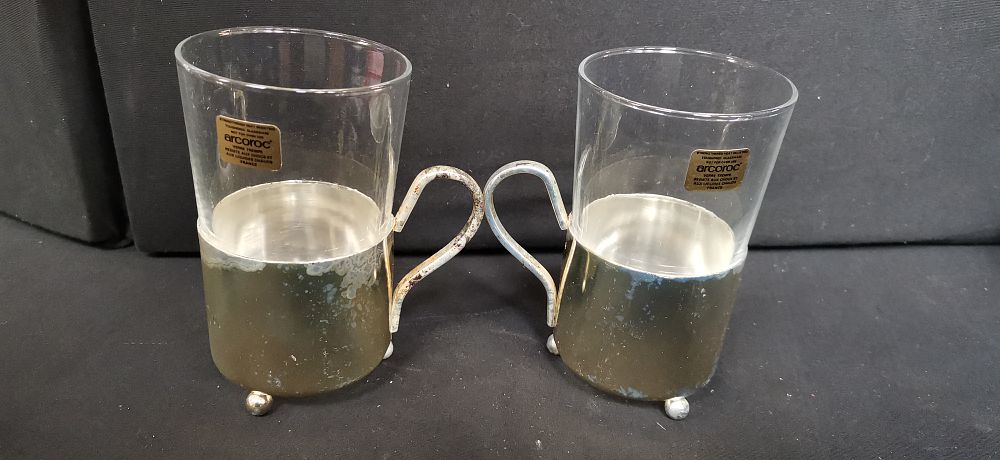 Lot 442: A Pair of Arcoroc Glass Cups in Metal Holders