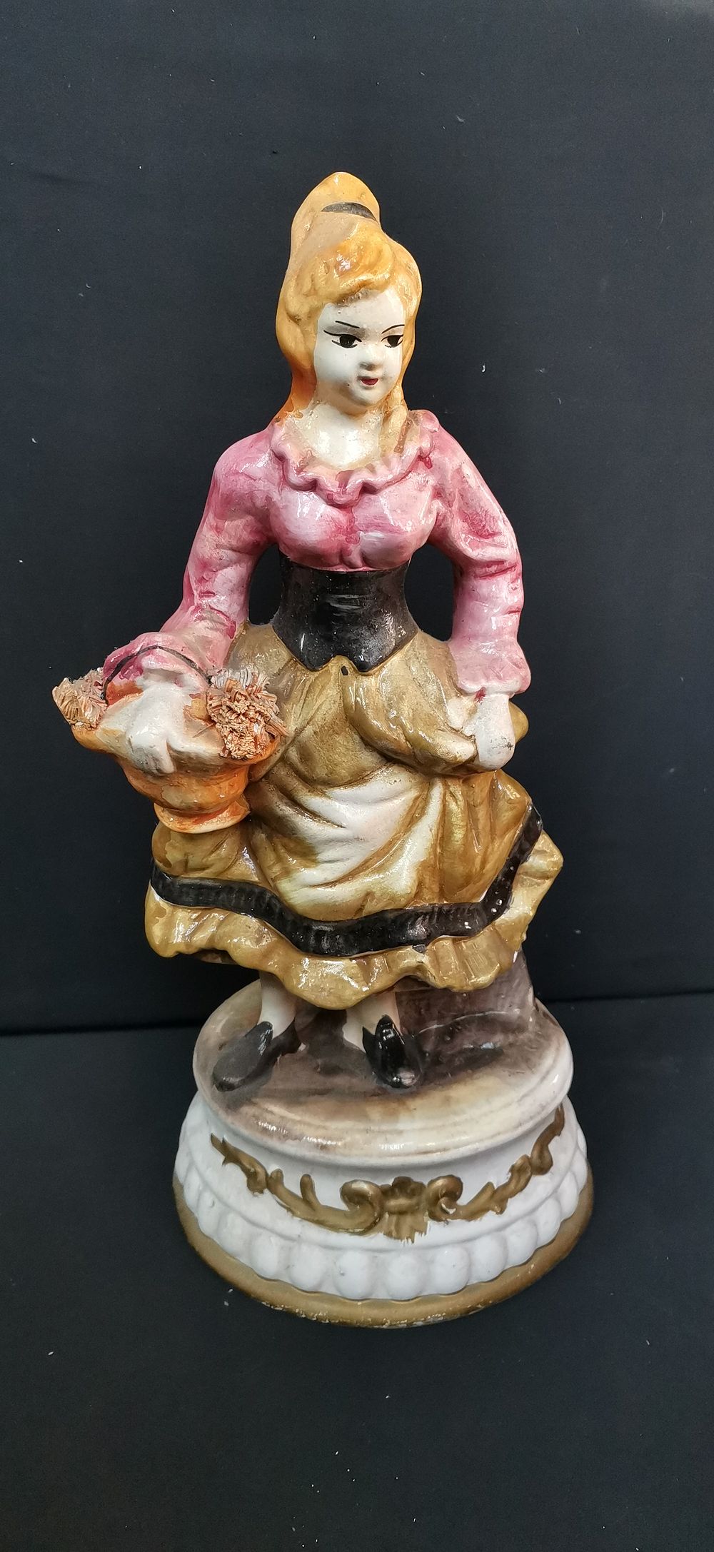 Lot 489: Ceramic figurine of a woman with a flower basket