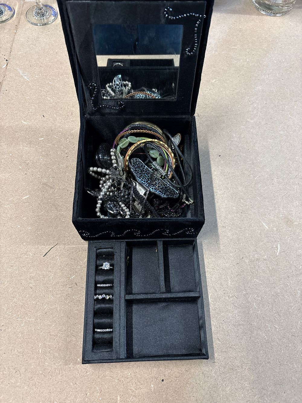 Lot 181: A selection of costume jewellery and a black velvet-lined storage box