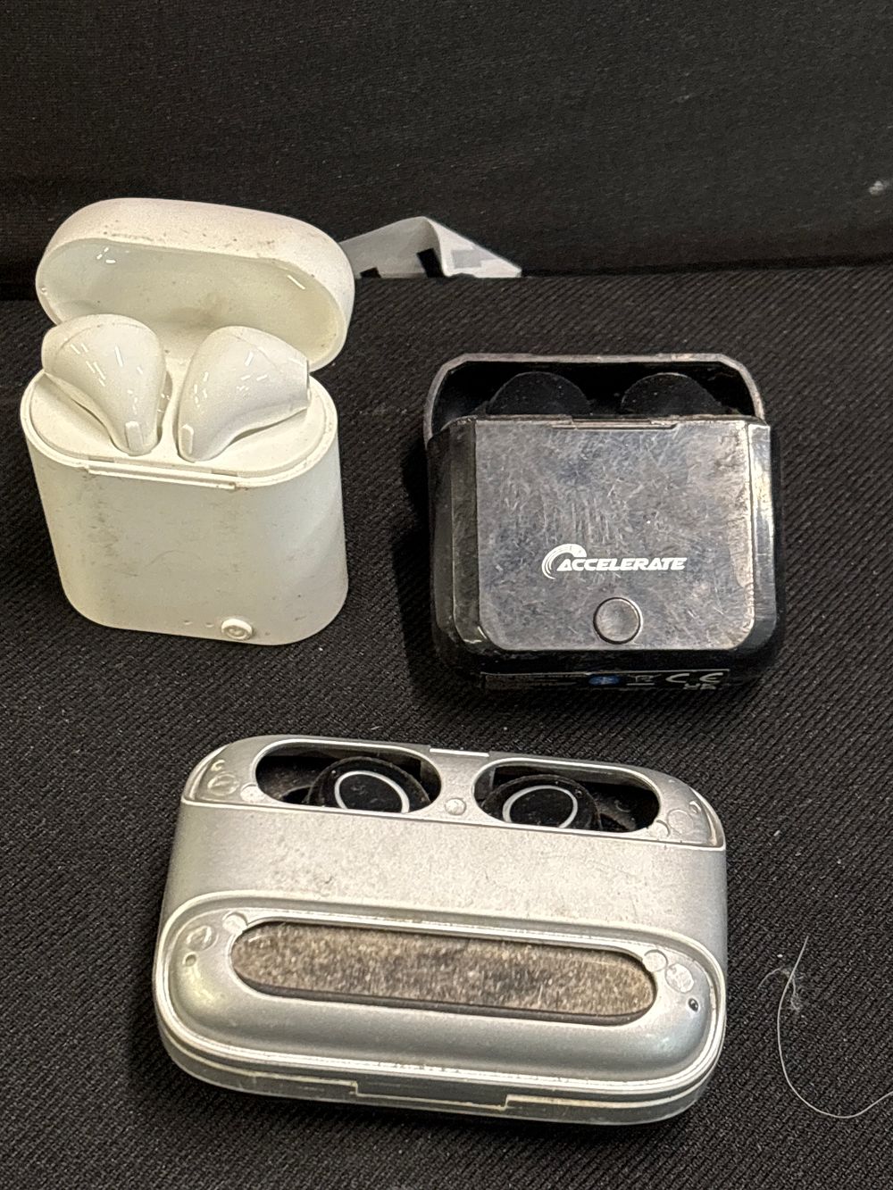 Lot 192: Accelerate and Unbranded, Three Pairs of Wireless Earbuds, Portable Charging Cases, c. 2018-2023