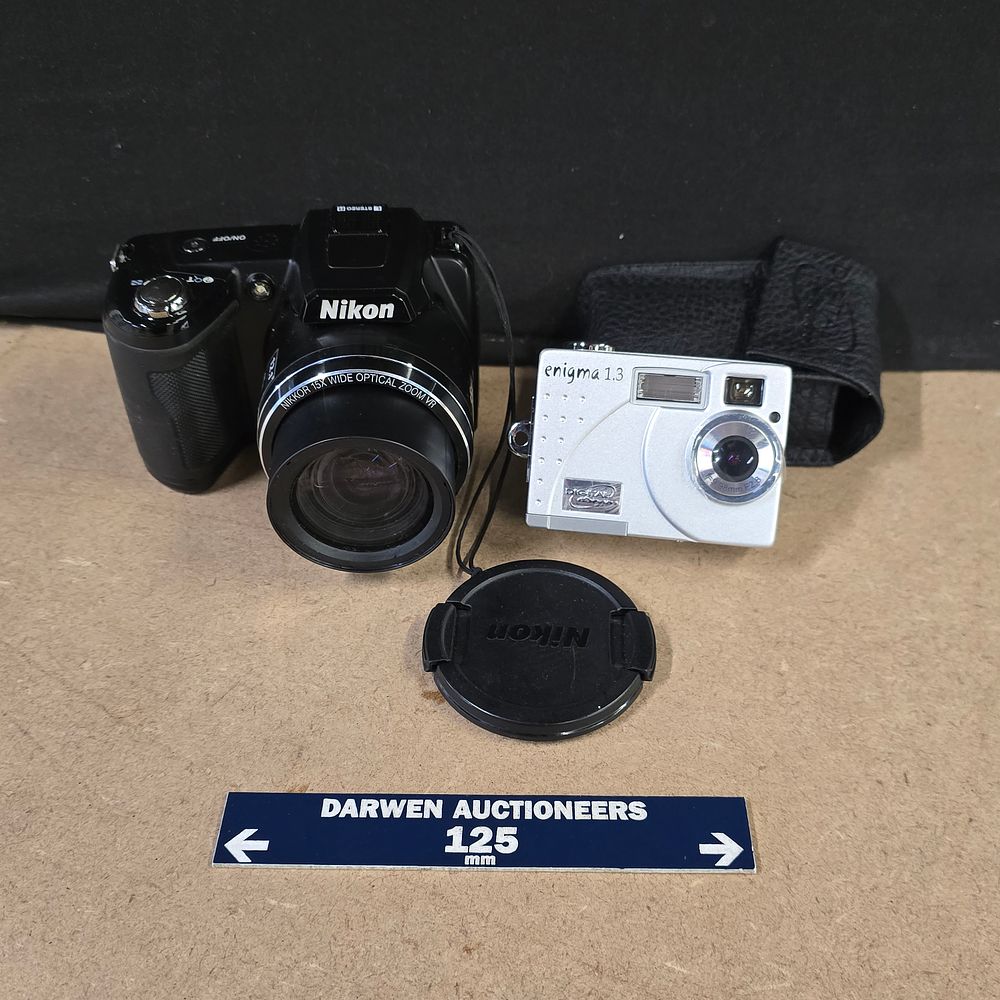 Lot 246: A Pair of Digital Cameras comprising a Nikon Coolpix L110 and an Enigma 1.3