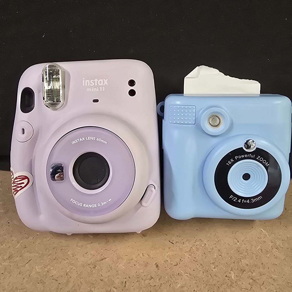Lot 250: A Pair of Instant Cameras comprising a Fujifilm Instax Mini 11 and a Children's Digital Print Camera
