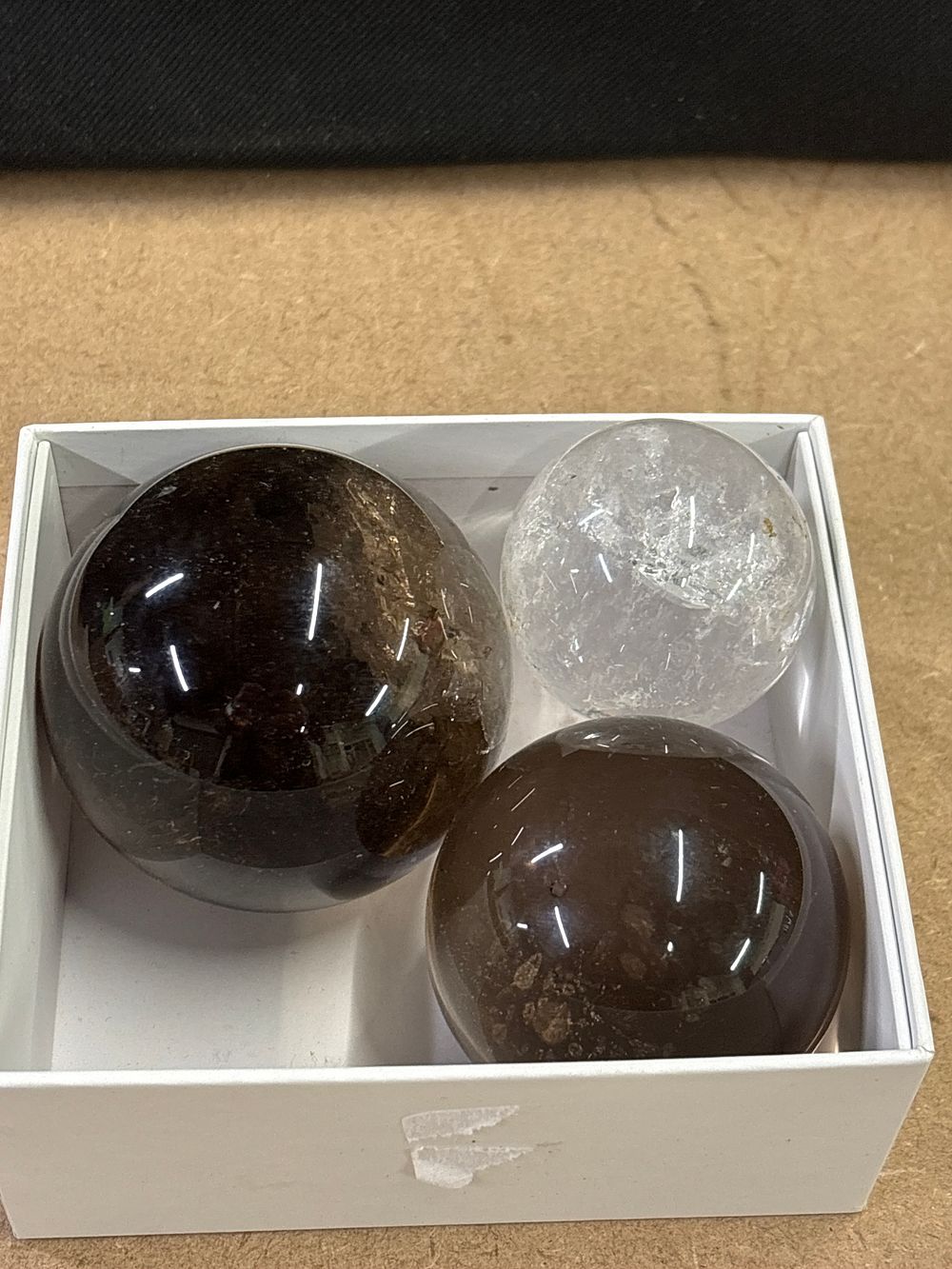 Lot 293: Three Polished Smoky and Clear Quartz Spheres