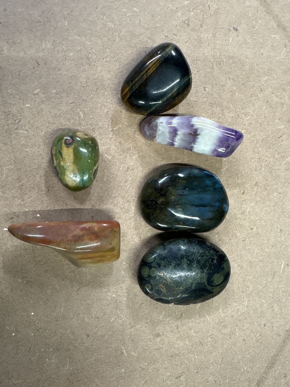 Lot 294: Six polished crystal gemstones including amethyst hematite and tigers eye