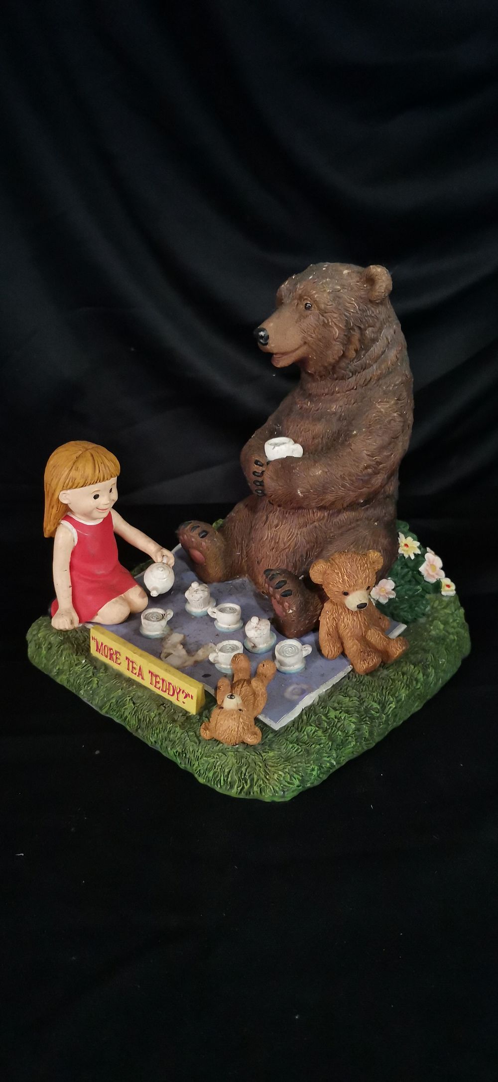 Lot 214: Resin figurine of a girl and bears tea party