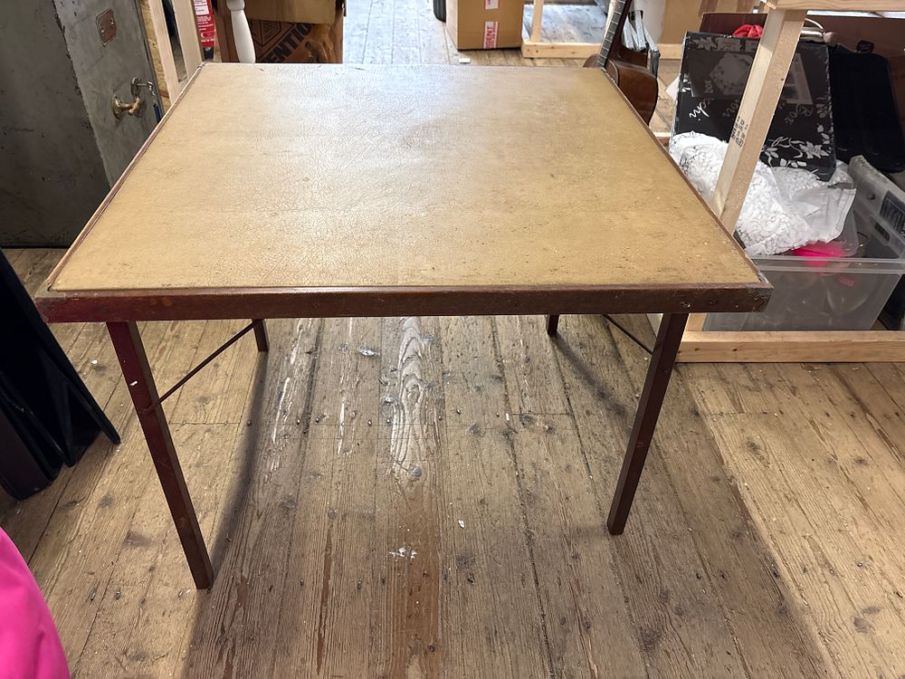 Lot 335: A Mid-Century Modern Wood and Leather Topped Folding Games Table