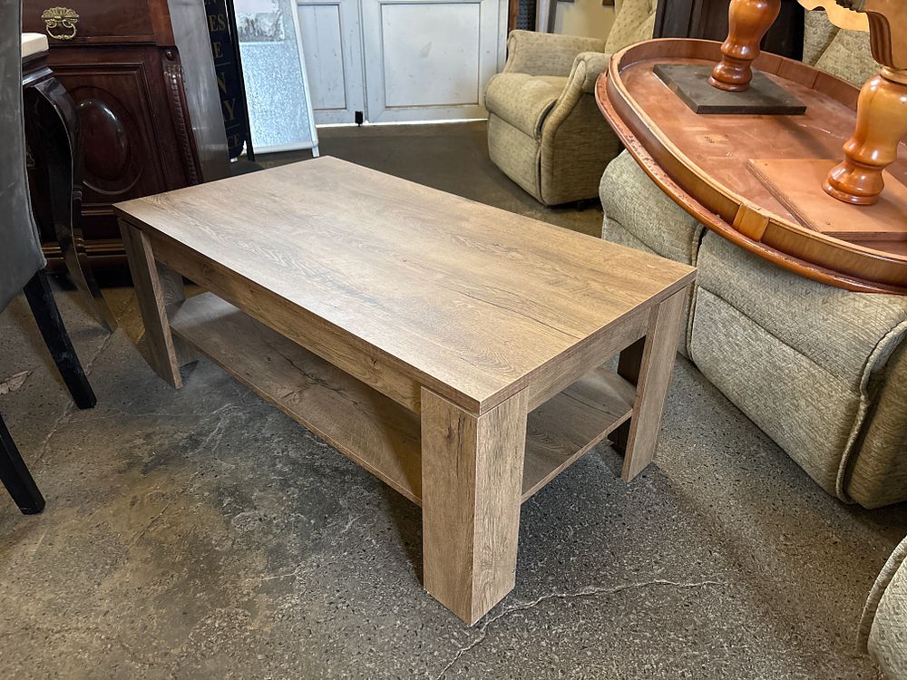 Lot 339: A modern wood coffee table with a light oak-effect finish