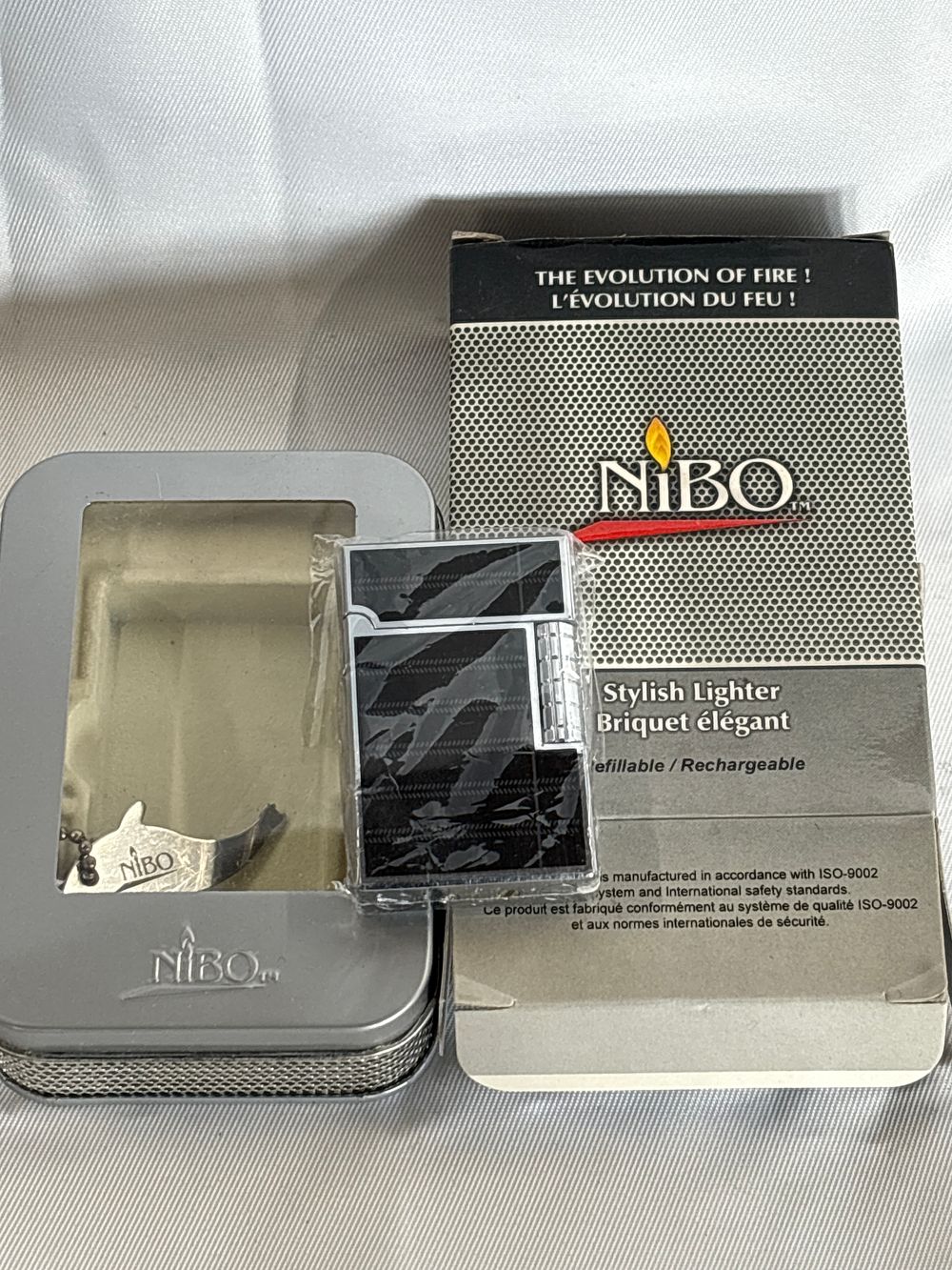 Lot 283: NIBO Refillable Single Flame Jet Lighter in Original Presentation Tin