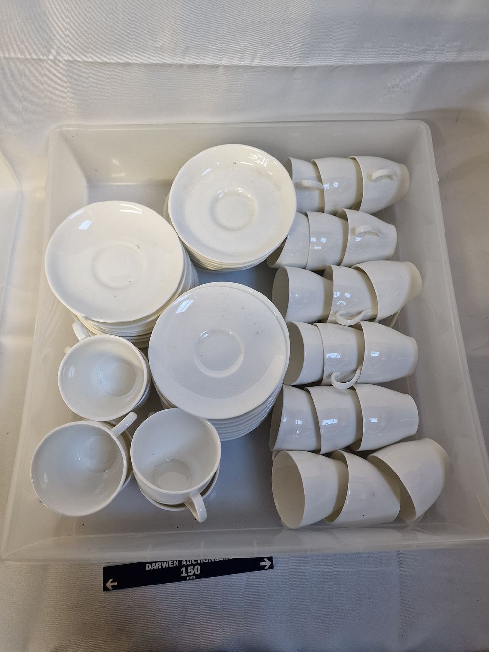 Lot 204: A set of 24 Royal Doulton white bone china tea and coffee cups and saucers