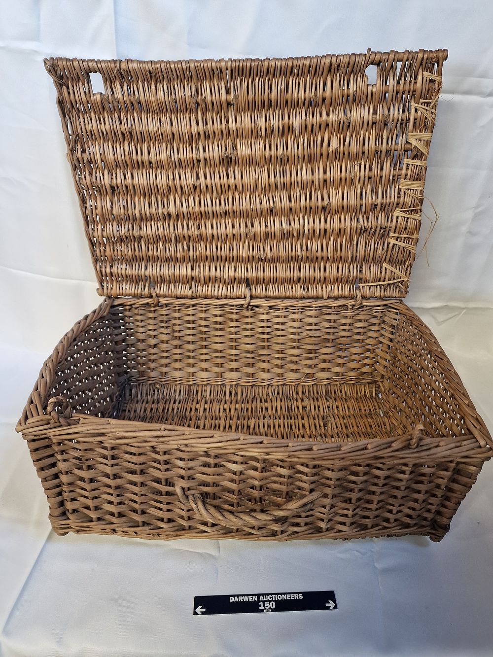 Lot 213: A vintage rectangular wicker storage hamper with hinged lid