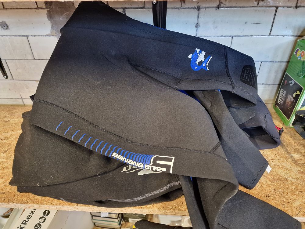 Lot 262: A collection of four wetsuits