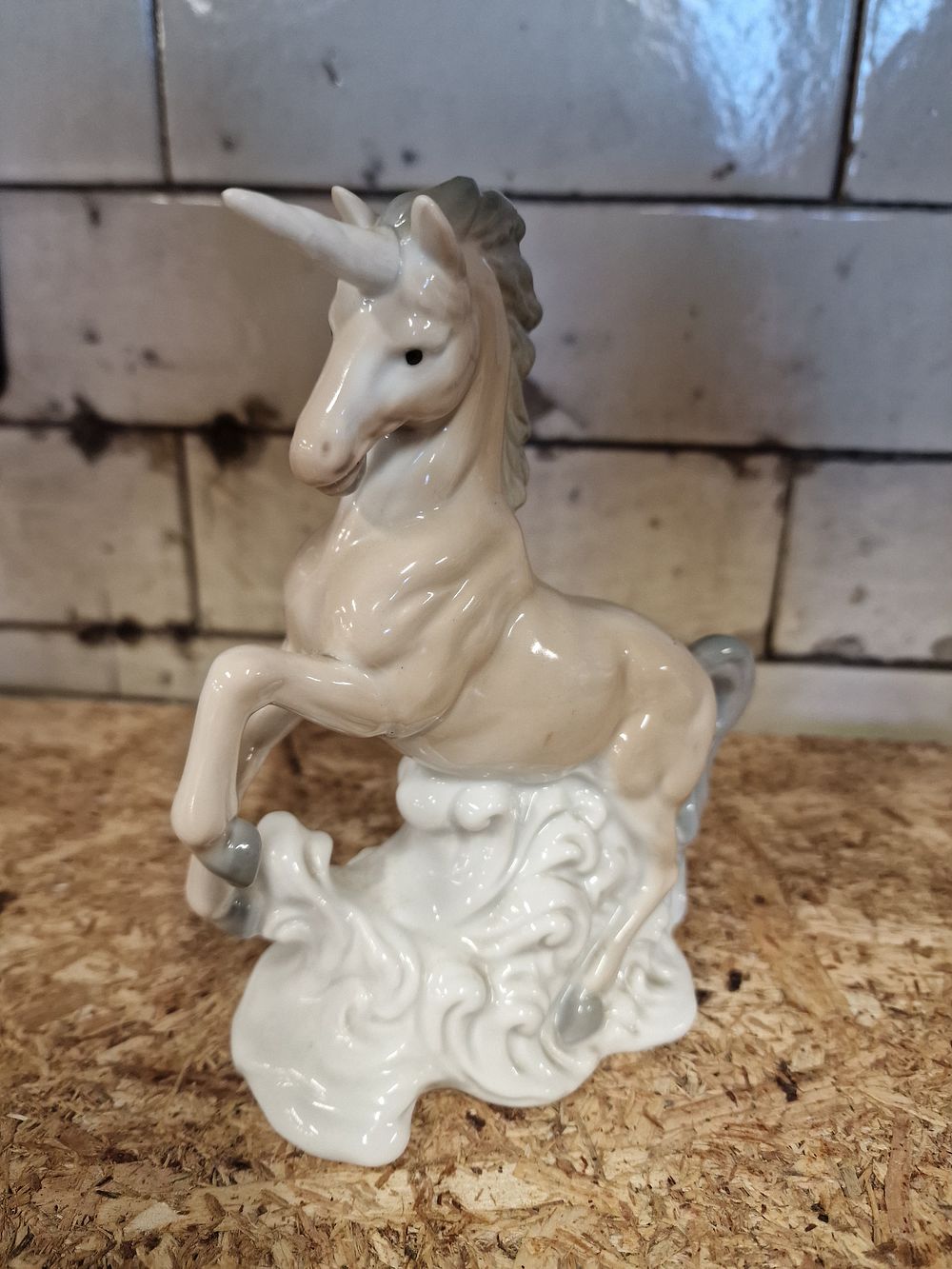 Lot 292: John Buck Japanese glazed porcelain rearing unicorn figurine